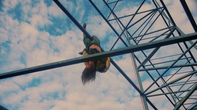 a man hanging upside down on a metal structure