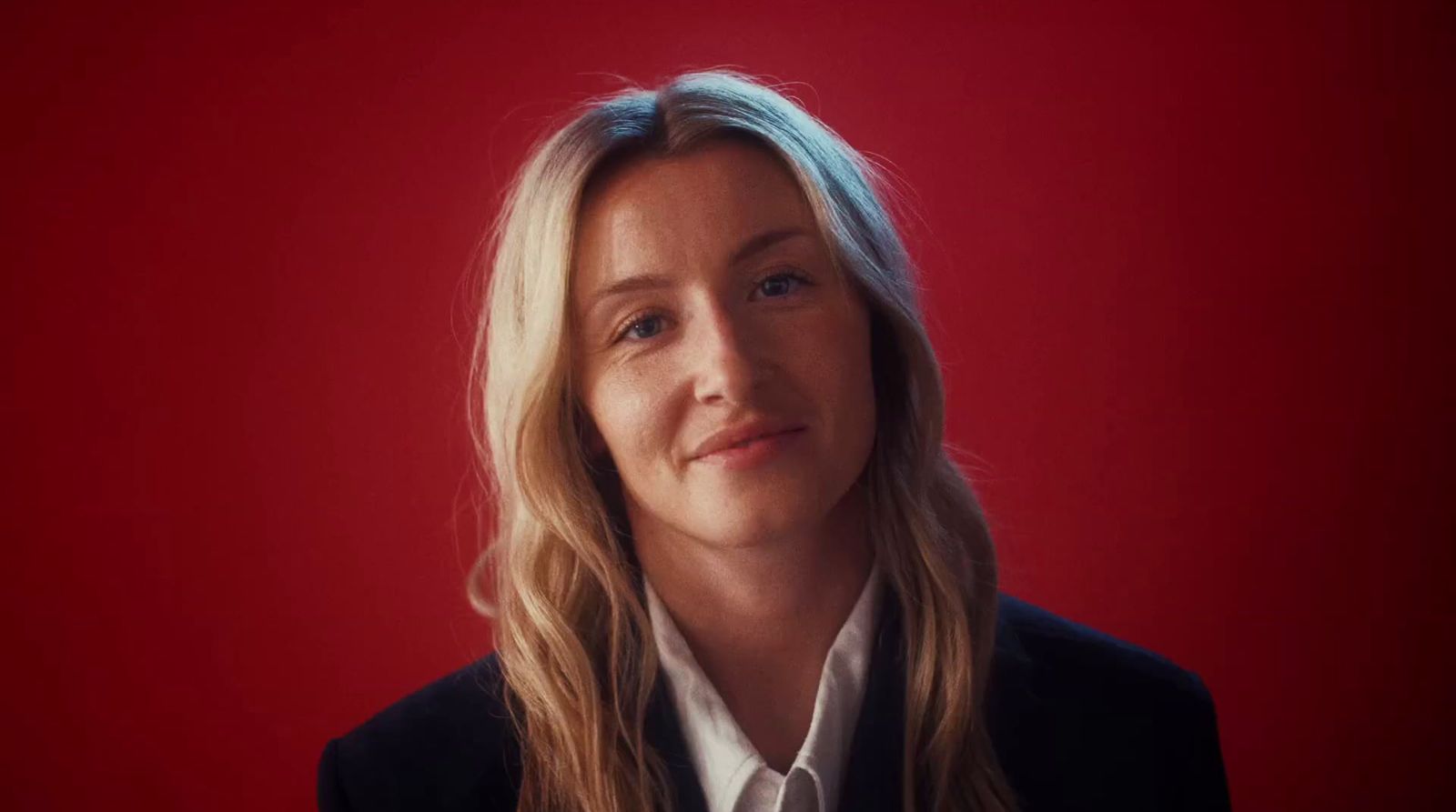 a woman in a black jacket and white shirt