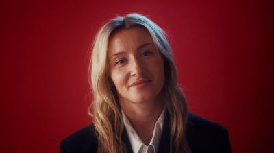 a woman in a black jacket and white shirt