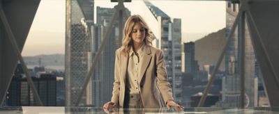 a woman standing in front of a glass table