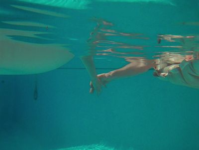 a man swimming under water in a pool