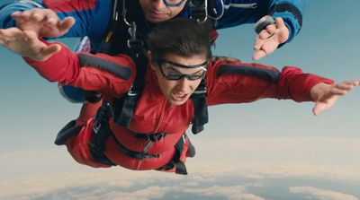 two people are sky diving in the sky