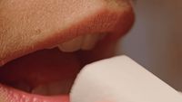 a close up of a person brushing their teeth