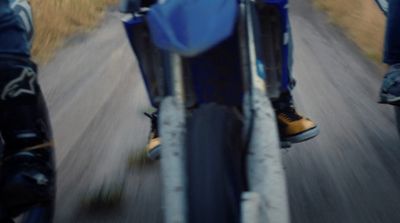 a close up of a person riding a motorcycle on a road