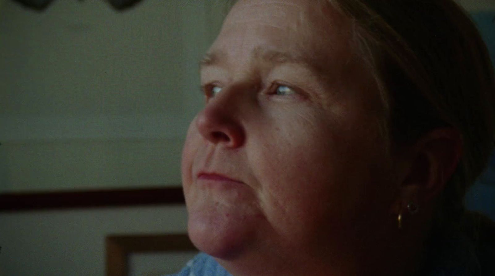 a close up of a person wearing a blue shirt