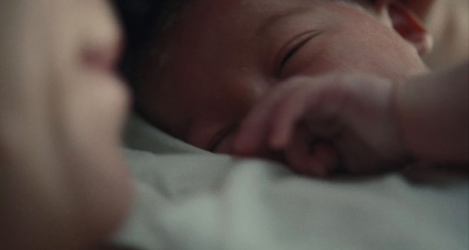 a close up of a person holding a baby