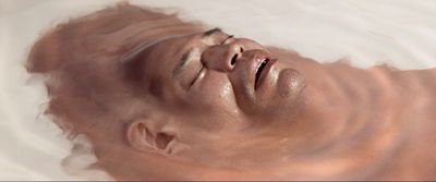 a man's face is partially submerged in water