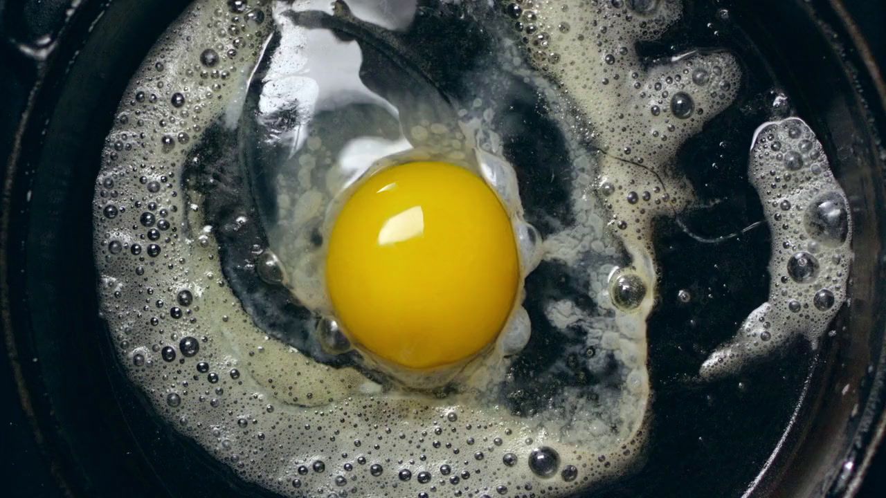 a fried egg in a frying pan on a stove