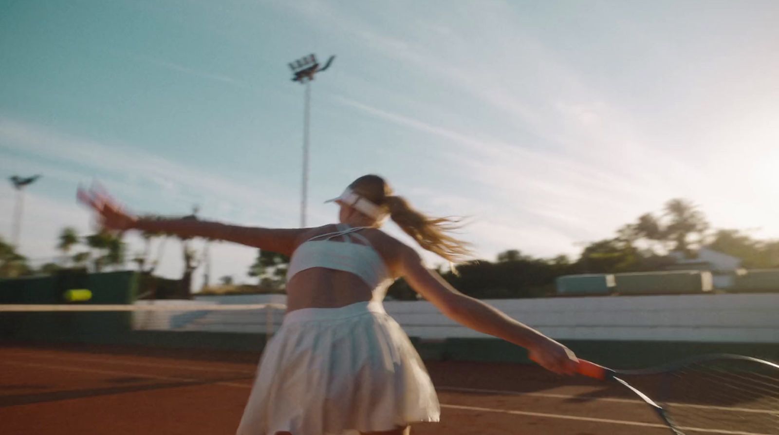 a woman is playing tennis on a tennis court