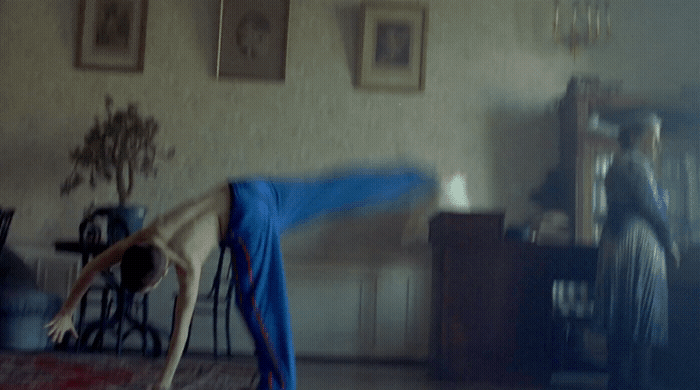 a person doing a handstand in a living room