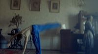 a person doing a handstand in a living room