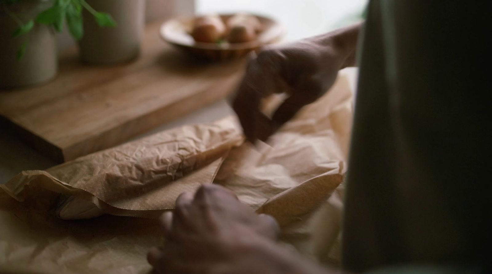 a person cutting up some food on a cutting board