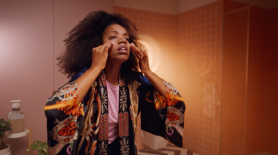 a woman in a bathroom brushing her teeth