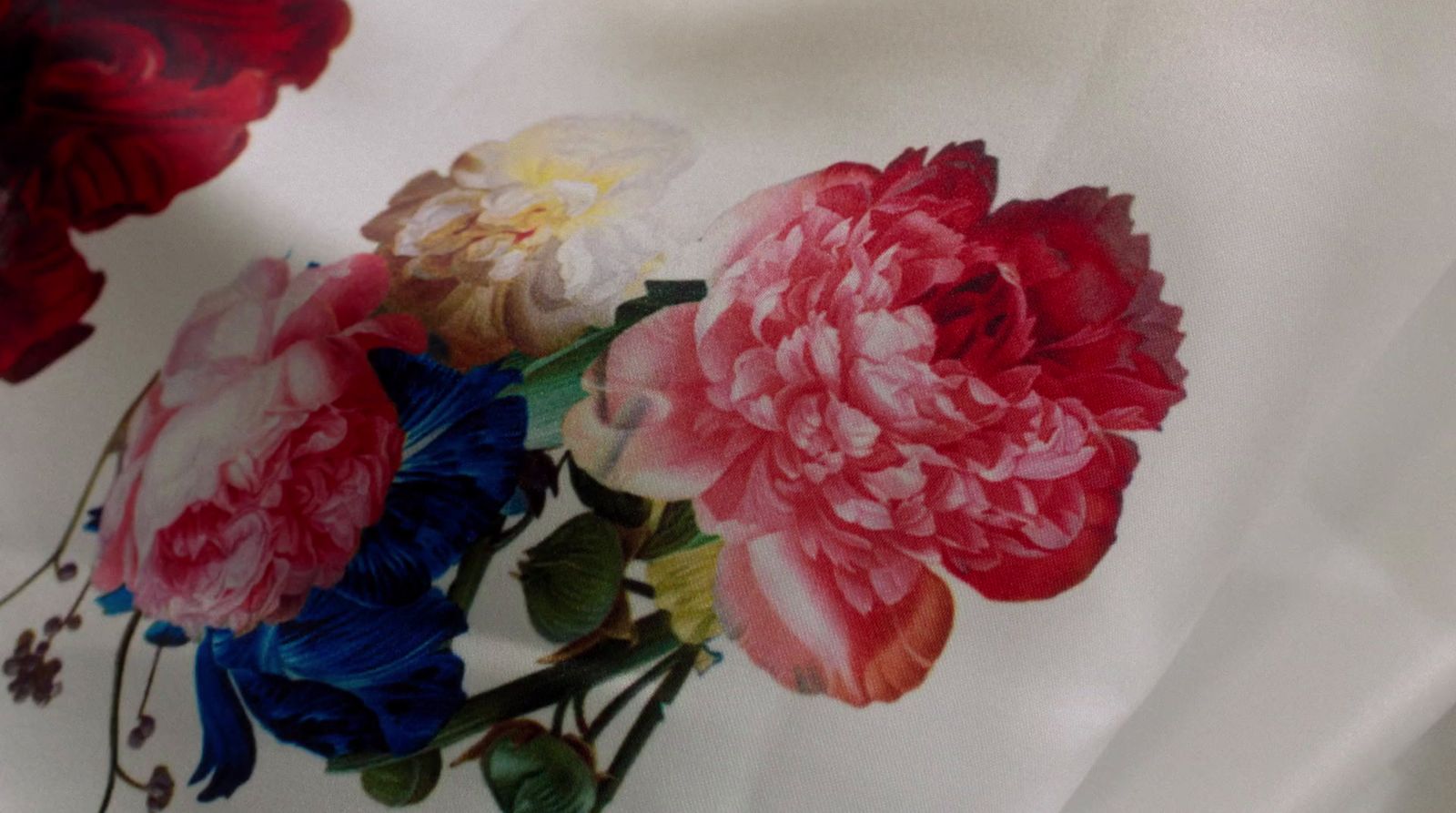 a bunch of flowers that are on a white cloth