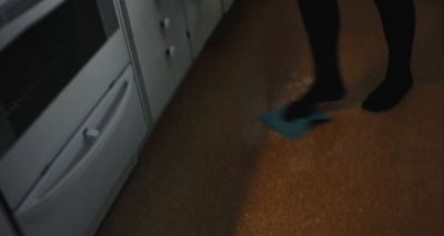 a person standing in a kitchen next to a stove