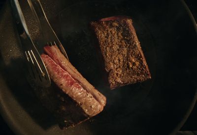 a piece of meat sitting on top of a frying pan