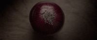 a close up of a red onion on a table