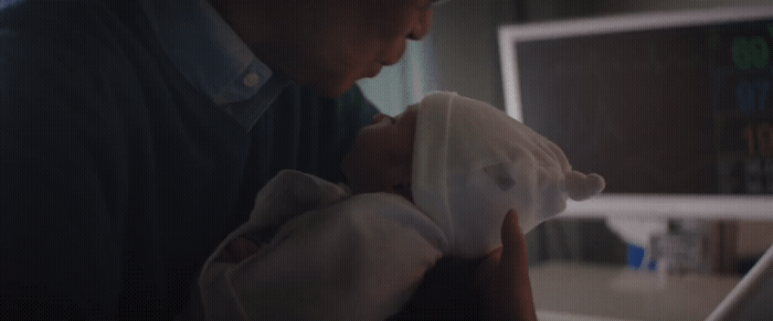 a man holding a baby in his arms