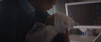a man holding a baby in his arms