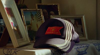 a hat sitting on top of a table next to pictures