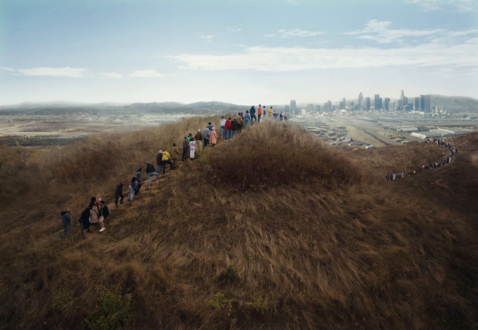 a group of people standing on top of a hill
