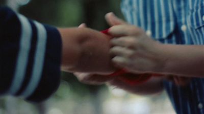 a close up of two people holding hands