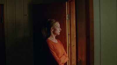 a woman standing in a doorway with her hands on her hips