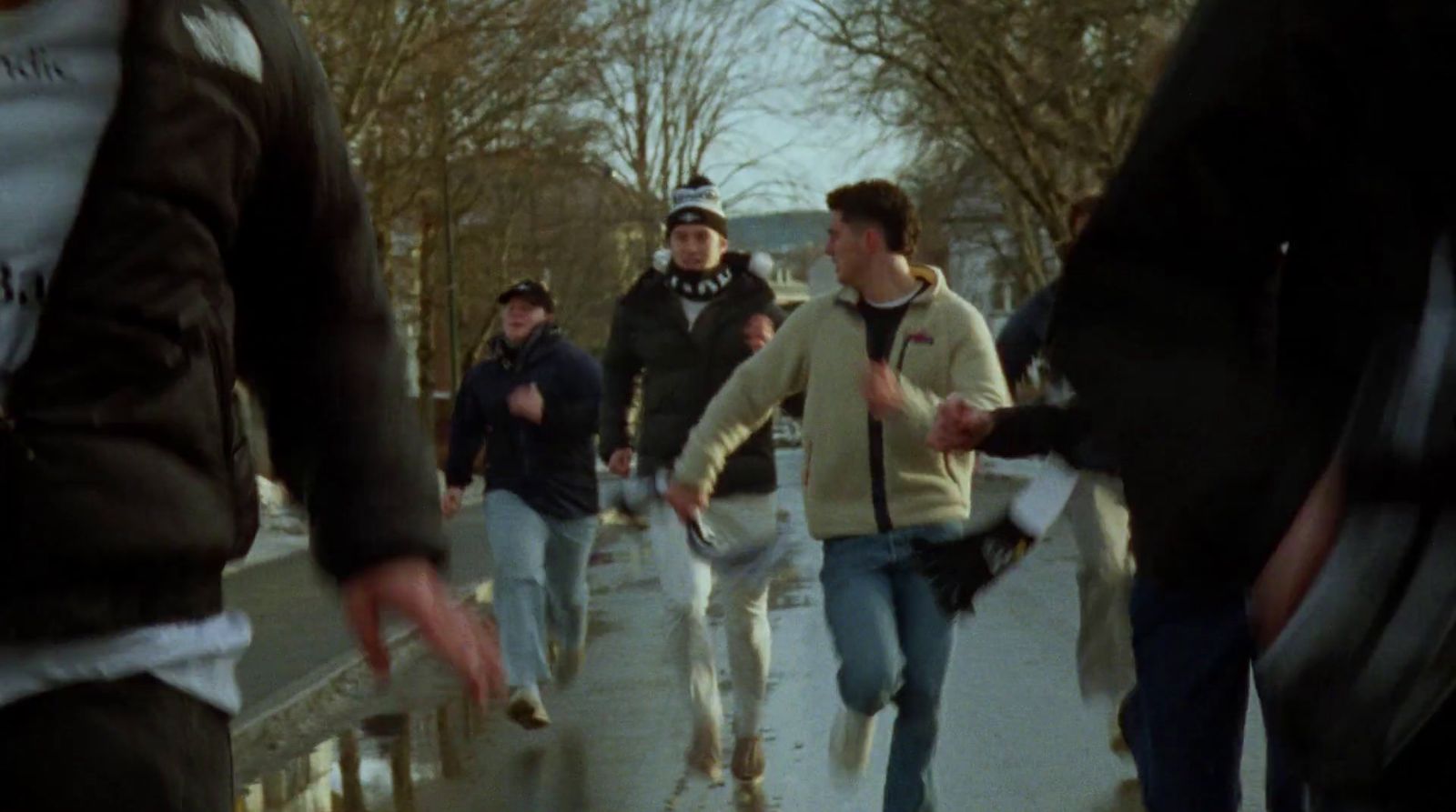 a group of people walking down a sidewalk
