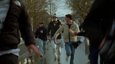 a group of people walking down a sidewalk