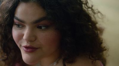a close up of a woman with curly hair