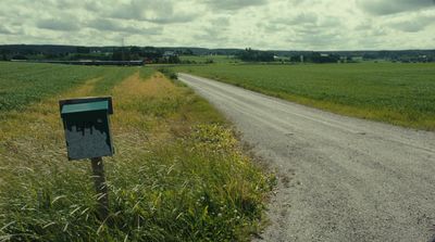 a sign on the side of a dirt road