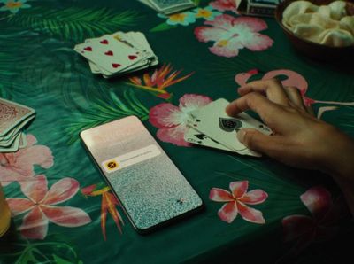 a table topped with cards and a cell phone