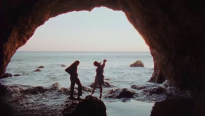 a couple of people that are standing in a cave