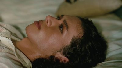 a close up of a person laying on a bed