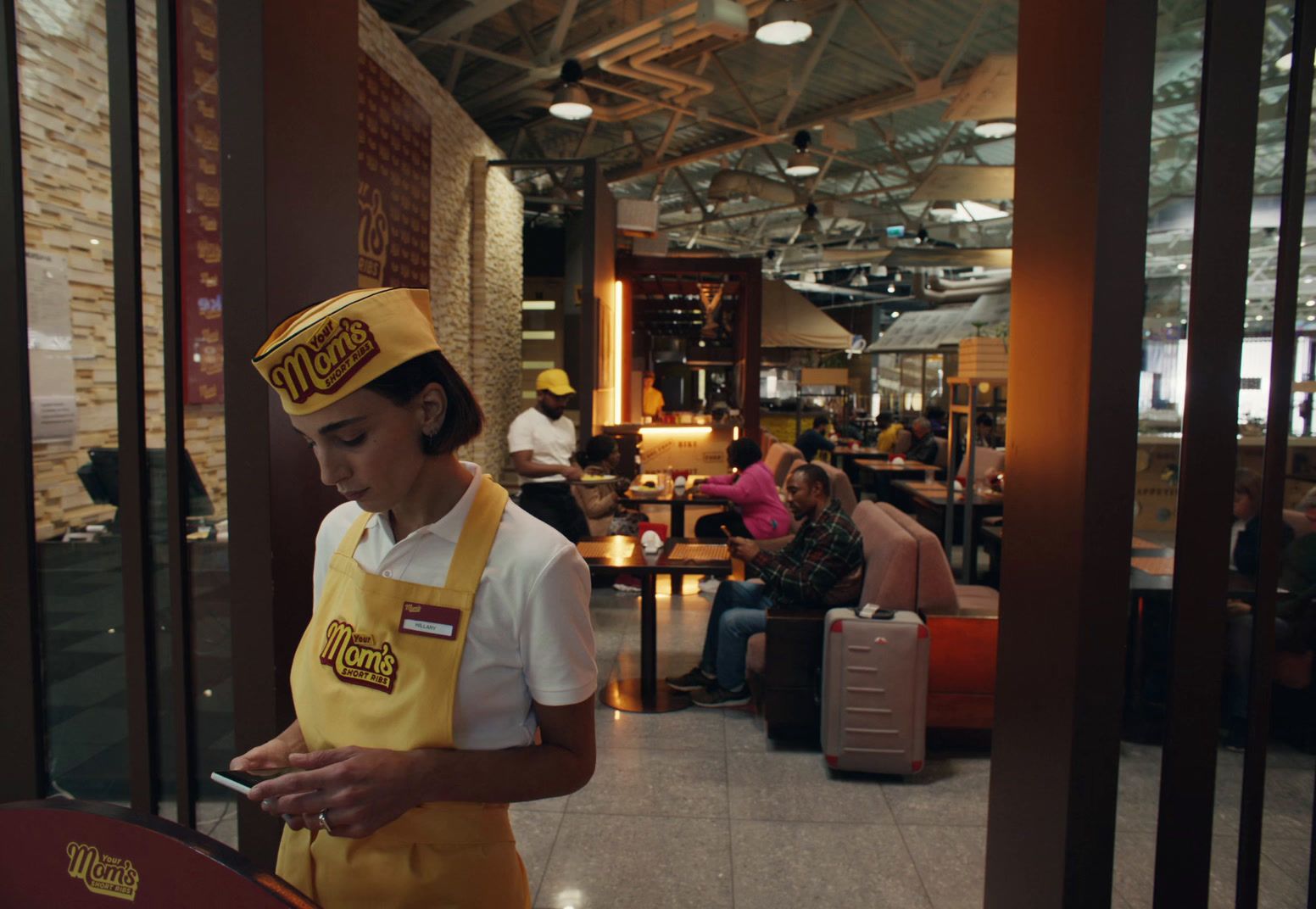 a woman in a restaurant looking at her cell phone