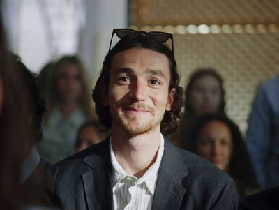 a man in a suit and tie wearing sunglasses