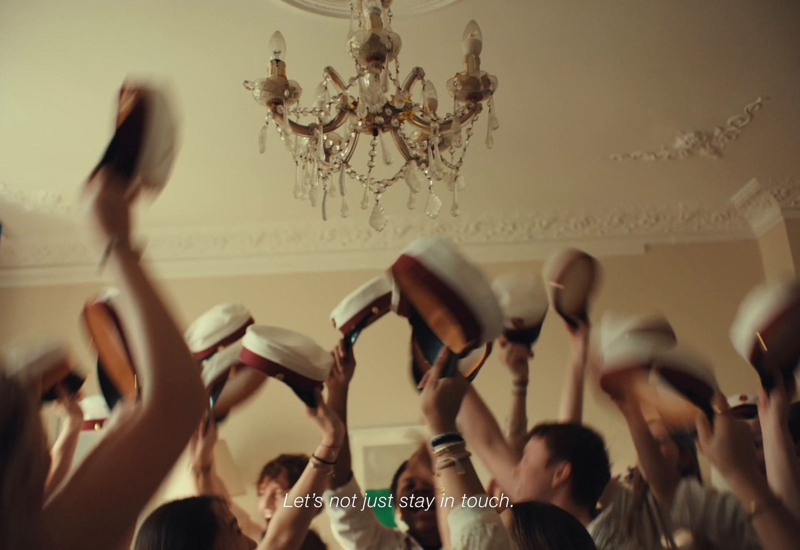 a group of people holding up hats in the air