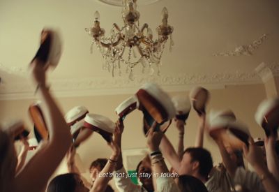 a group of people holding up hats in the air
