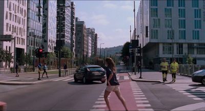 a group of people crossing a street at a crosswalk