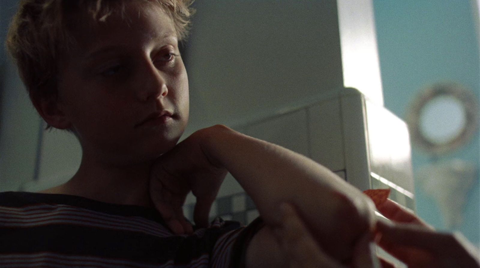 a young boy is holding something in his hand