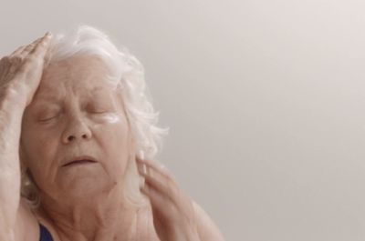 a woman holding her head in her hands