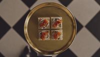 a plate of food on a table with a checkered floor