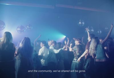 a group of people dancing in a club