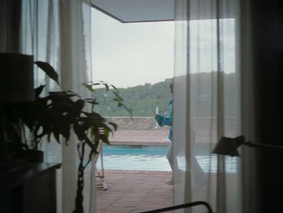 a woman standing in front of a swimming pool