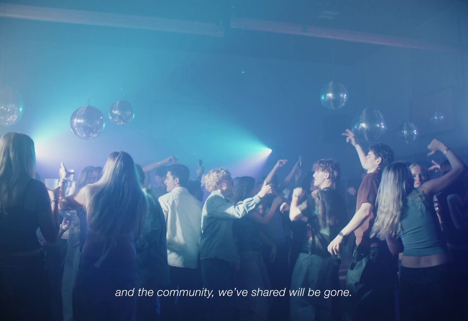 a group of young people dancing in a club