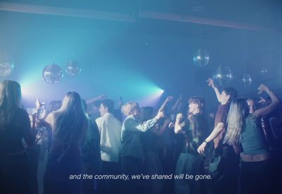 a group of young people dancing in a club