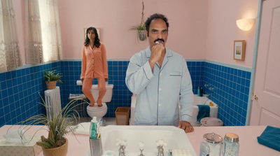 a man standing in front of a bathroom sink