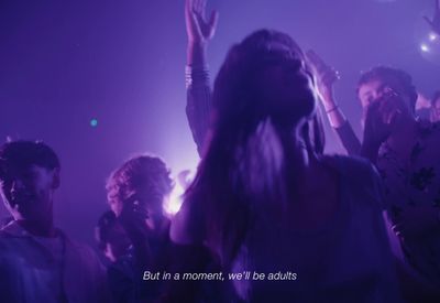 a group of people standing around each other