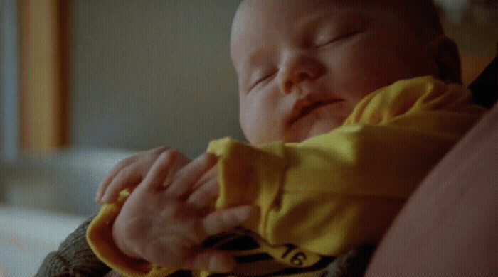 a close up of a person holding a baby
