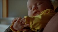 a close up of a person holding a baby